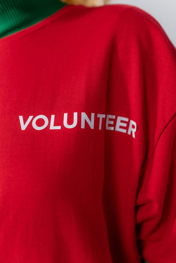 Close-up of a red shirt with volunteer text, perfect for charity themes.